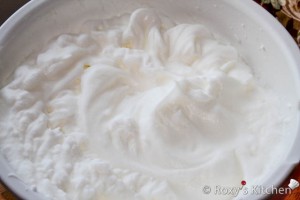 Beat egg whites and water with an electric mixer until stiff peaks form. 