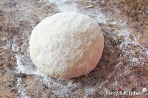 Easter Cake with Cheese (Pasca cu Branza) - Cut the dough into two equal parts and roll one part of the dough. 