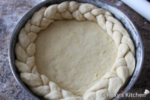 Easter Cake with Cheese (Pasca cu Branza) - arrange the braided rope in a ring on top of the sheet of dough from the pan.