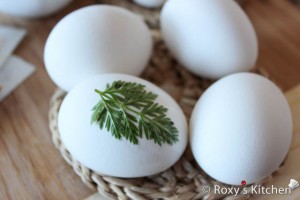 Easter Eggs with Leaf Imprints - Stick the leaves on the hard-boiled eggs while they are still hot.