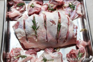 Roasted Lamb with Garlic & Rosemary - Place garlic pieces and fresh rosemary into each slit. 