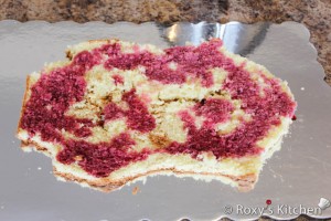 Lamb Cake - Cut the bigger cake horizontally in three. Moist the cake layers with the syrup from the sour cherries. 