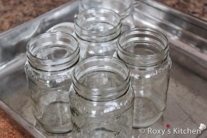 Wash the jars in soapy water and rinse them thoroughly. Allow them to drip-dry for 15-20 minutes and then place them in a pan (or right on the rack) in the oven set to 225F (100C) to sterilize the jars