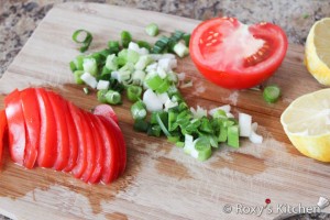 Cut tomatoes & green onions.