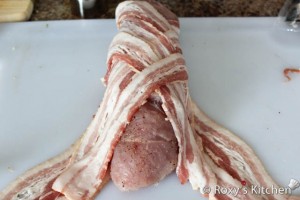 Turkey Breast Wrapped in Bacon - Place the rolled turkey breast in the center of the bacon and then crisscross the bacon around the turkey.