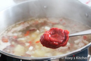 Country-Style Soup (Ciorba Taraneasca) - Season with salt and pepper and add the tomato paste.