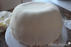 Pumpkin Cake - Smooth the fondant and trim the edges at the bottom.