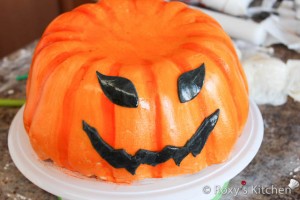 Pumpkin Cake - Make the eyes and mouth out of black fondant and attach them onto the cake by brushing the back of the decorations with sugar syrup.