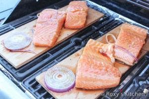 Cedar Plank-Grilled Salmon - Preheat the grill to 180°C (350°F) and place the planks on the grills. When they start to smoke, lay the salmon fillets on the planks skin-side down.