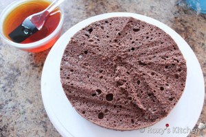 Topsy Turvy Chocolate Cake -  Moisten the cake with sugar syrup using a brush.