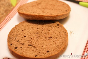 Cut the bowl-shaped cake (this will be your belly) horizontally in three and the round cake in two.