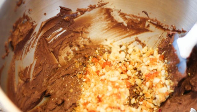 Mix in the chopped hazelnuts in 2/3 of the mixture. You will use the remaining to crumb coat the cake.
