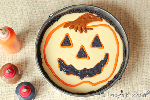 Decorated Pumpkin Cheesecake - Fill in the stem using the brown batter and the eyes and mouth using the black batter.