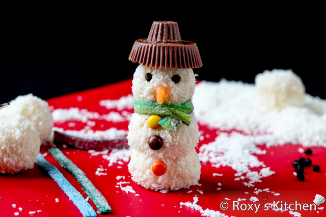 Homemade Raffaello Snowmen - Place a small peanut butter cup on top of a larger one to make the hat and attach it to the snowman using candy coating as glue. 