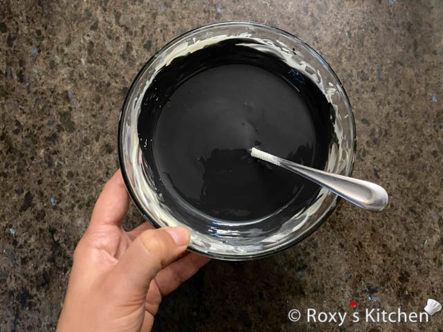 Colour the chocolate using black oil-based or gel food colouring.