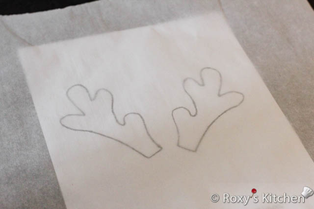 Print out the reindeer antlers template. Then, place a piece of parchment paper on top. 