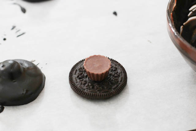 Split the Oreos and remove the filling. Then, on three of the Oreo halves, place a peanut butter cup. You can attach it to the cookie using a bit of melted chocolate. 