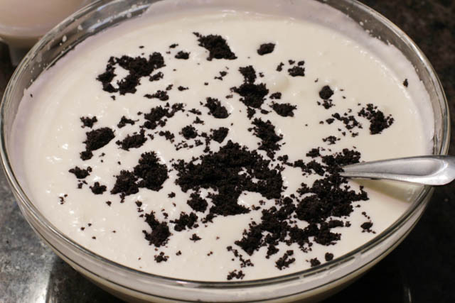 Add 2 tablespoons of finely crushed Oreos to the mousse and gently stir it a few times. 