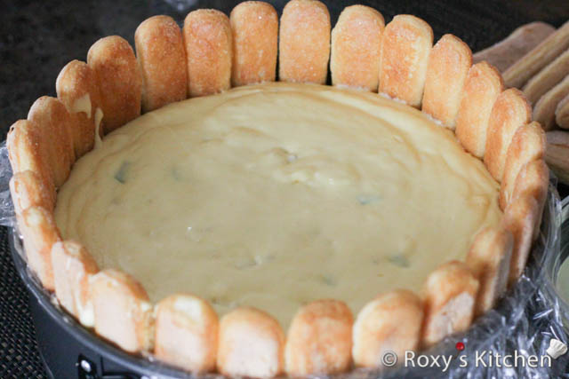 Then, pour the cake filling into the pan and add a layer of lady fingers with the dipped side down. 