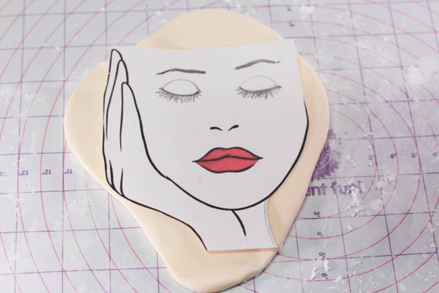 Place your cut-out image on the fondant. Cut out the outline with the X-acto knife. 
