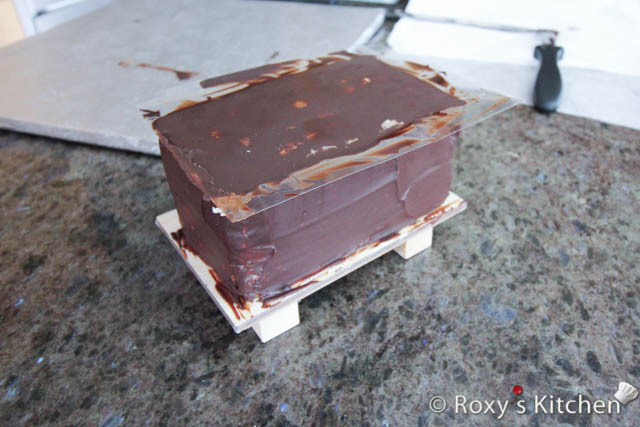 Crumb coat the train cars with a thin layer of the ganache.