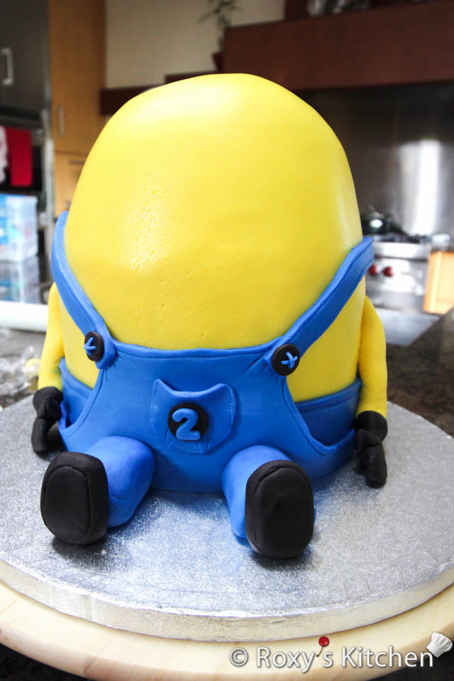 Make the legs out of blue fondant and black fondant as seen in the picture.