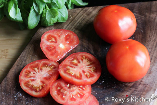 Slice the tomatoes and mozzarella cheese into 1/4 inch thick slices. Season the tomato slices with salt. 