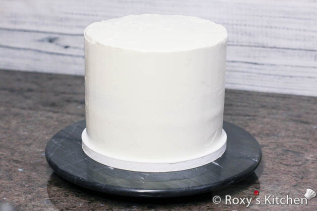 Apply the remaining frosting and smooth it out using a spatula and a cake scraper/smoother or a bench scraper. 