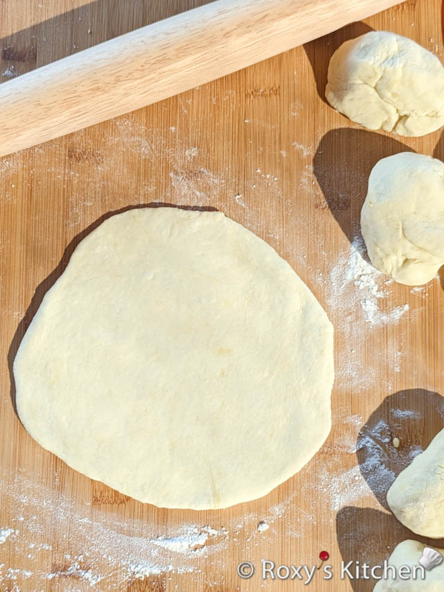 Lightly flour your work surface, and roll each dough ball to form the pita bread. 
