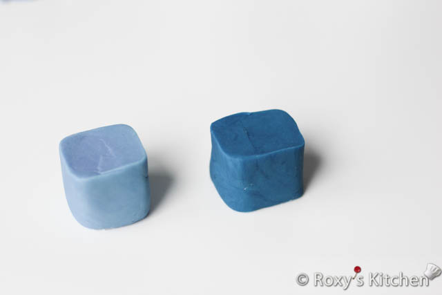 The baby cubes are just shaped and cut by hand. I rolled the blue fondant into a log that was about 3.8 cm (1.5’’) in diameter. Then, I gave this square-round edges and cut the log into 3.8 cm (1.5’’) squares. 