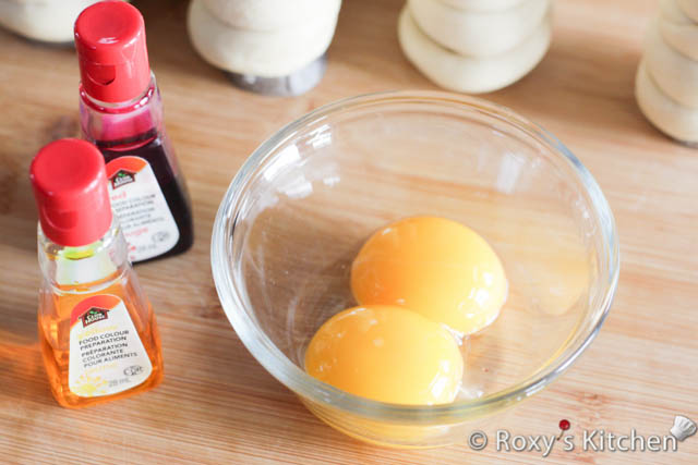 Beat the two egg yolks lightly and then add the food colouring to achieve a dark orange colour. It will look lighter once you brush the dough with it. 