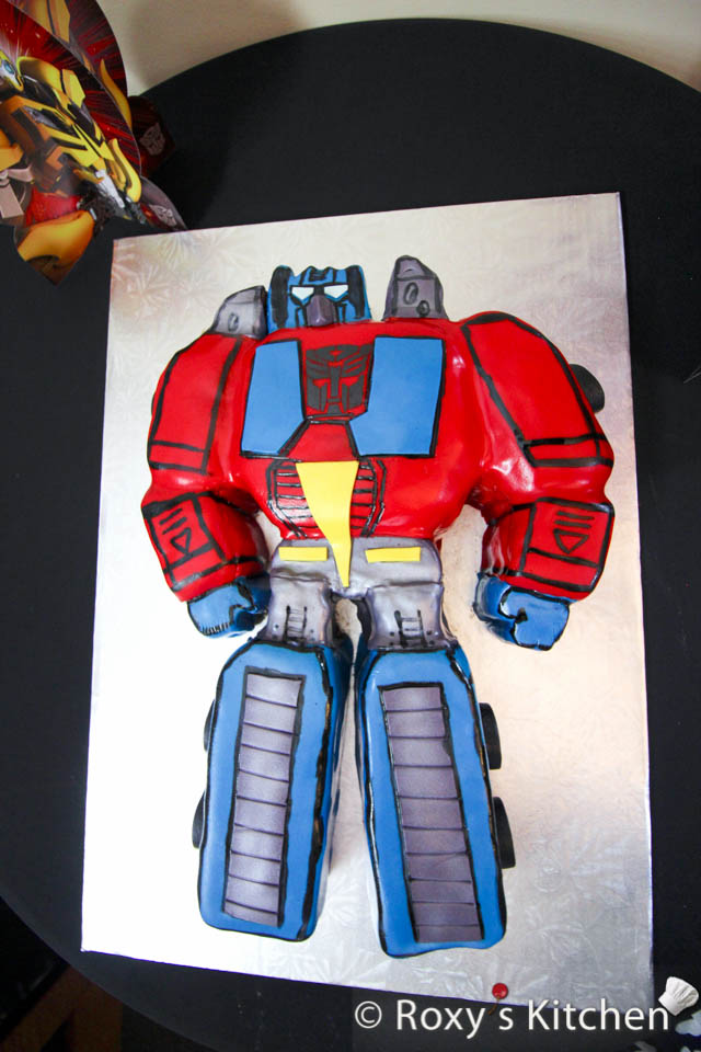 Optimus Prime Cake Tutorial - Brush the grey fondant with silver decorative cake paint or just a silver lister dust. Trace the black outline and other details using a thin paint brush and food colouring. Mix a bit of black gel food colouring with a drop of clear alcohol (such as vodka) or food-grade extract to achieve a paint-like consistency.