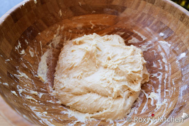 If kneading by hand, transfer the dough to a floured surface and knead for about 6-8 minutes until the dough becomes smooth and elastic. The dough will still have a sticky consistency. 