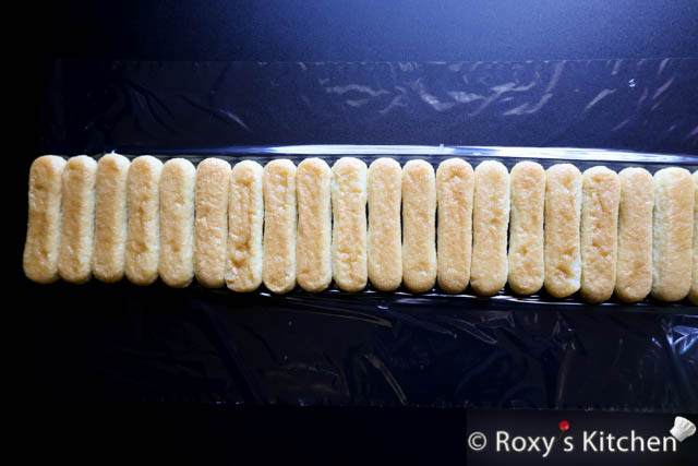 Dip each ladyfinger cookie into the syrup you saved earlier, soaking for 2-3 seconds on each side until lightly coated. 