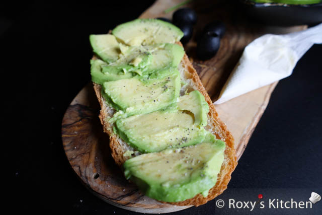 Place the avocado slices on the bread slice and season this with salt and pepper.