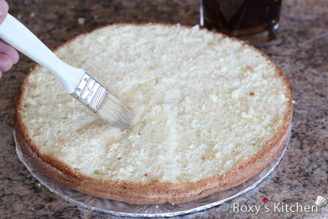 Moisten the cake with sugar syrup using a brush.