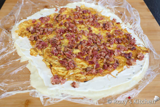 Sprinkle the remaining bacon crumbles or sausage pieces evenly on top. 