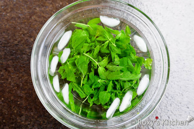 Remove the mint leaves from the water and immediately transfer them to the bowl of ice water to cool and stop the cooking process. Let them sit in the ice water for a minute or two.