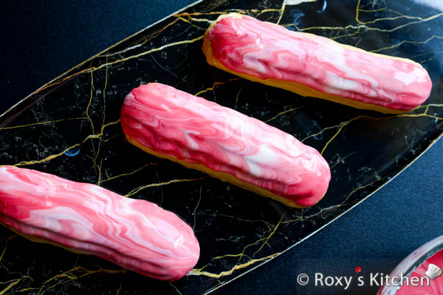 7 Quick, Easy & Elegant Éclair Glazes - Eclairs Topped with a White & Red Chocolate Glaze with a Marbled / Swirled Effect 