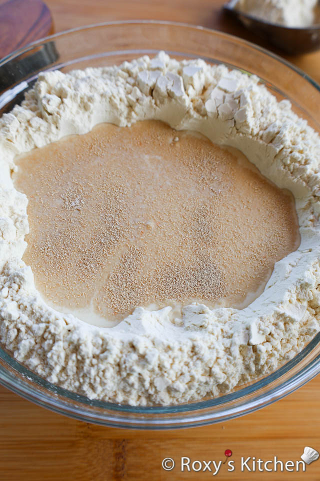 In a large mixing bowl, combine the flour and salt. Make a well in the centre. 

Pour the lukewarm water and lukewarm milk in the centre. Add the dry yeast. Stir until a dough forms.